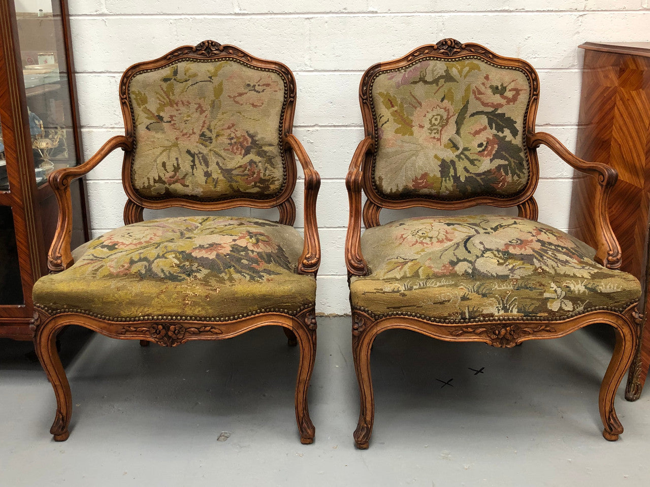 Pair of French Walnut Tapestry covered armchairs. They are in good original detailed condition. Slight wear and tear to fabric but still in good condition please view photos.