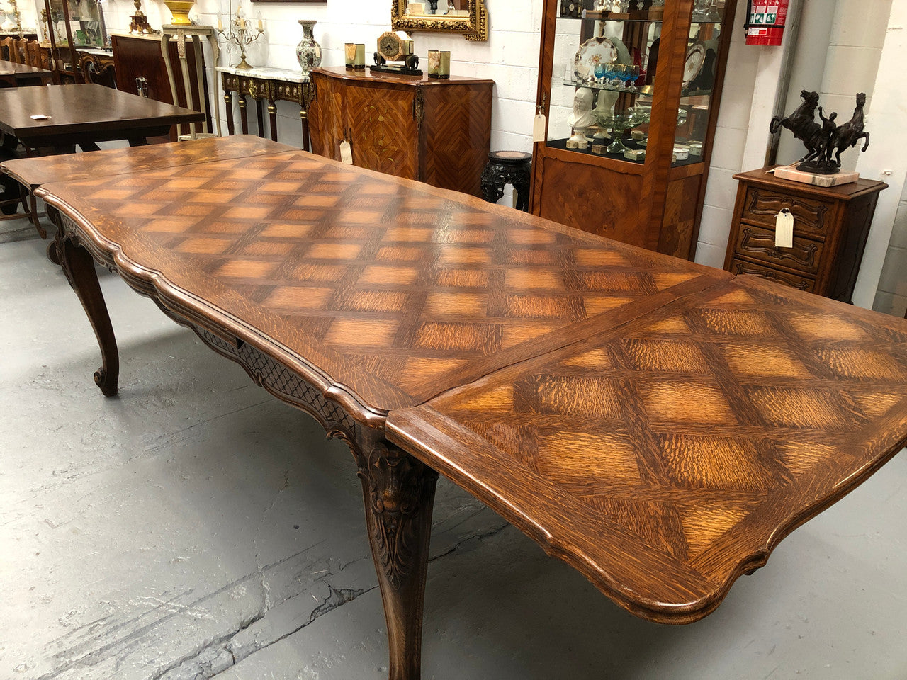 High quality French Oak Louis XV Style, beautifully carved extension table. It has an amazing parquetry top and when fully extended measures to 3 meters long. In very good original detailed condition.