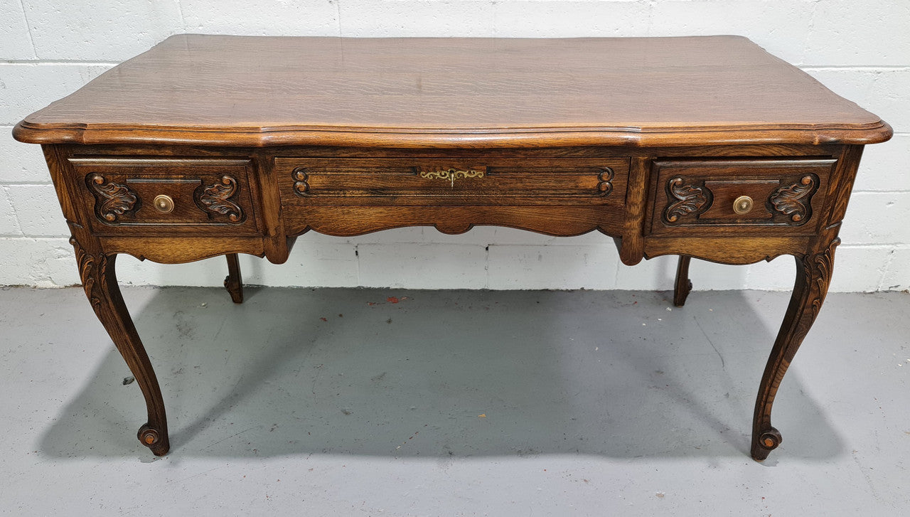 Attractive large Louis XV style Oak faux partners desk. Nicely carved details with three large functioning drawers, and three faux drawers at the back. In good original detailed condition.