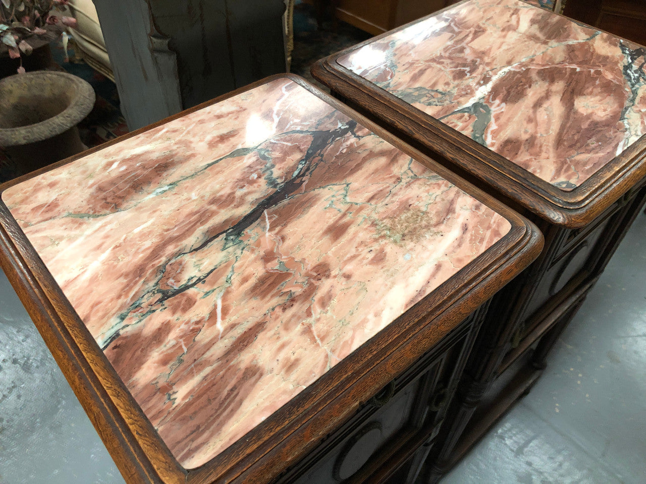 Lovely pair of French Oak Louis XVI style bedside cabinets with inset marble tops a drawer and a cupboard for storage. In good original detailed condition.