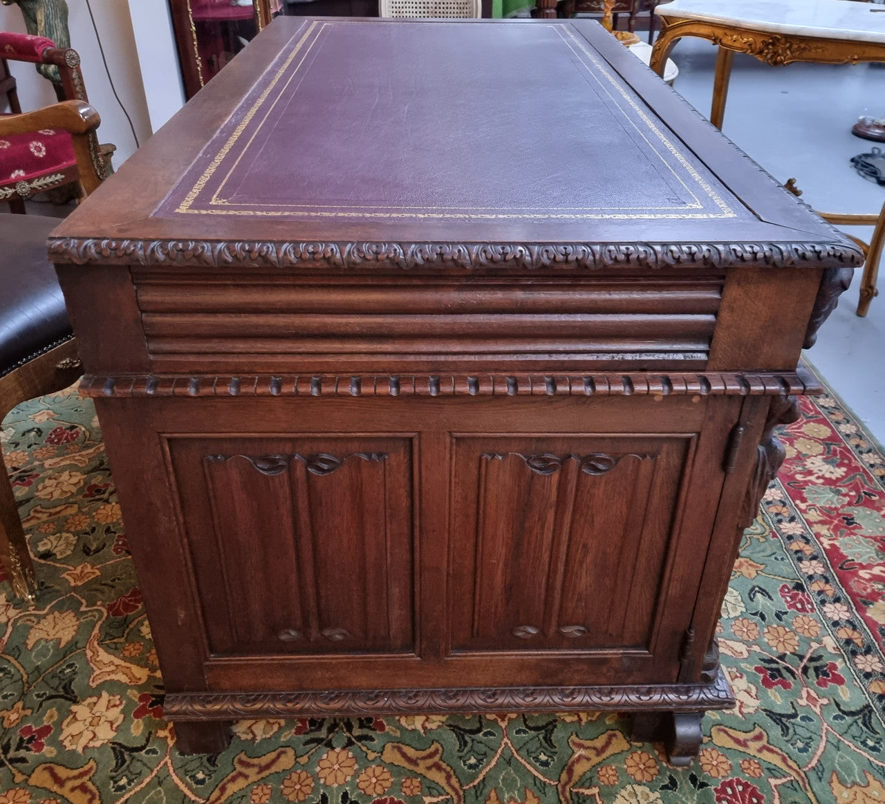 Beautifully carved French Oak early 19th century pedestal desk with 3 drawers, two cupboards and a secret cupboard on the side. There is also a lovely burgundy tooled leather top. In good original detailed condition.