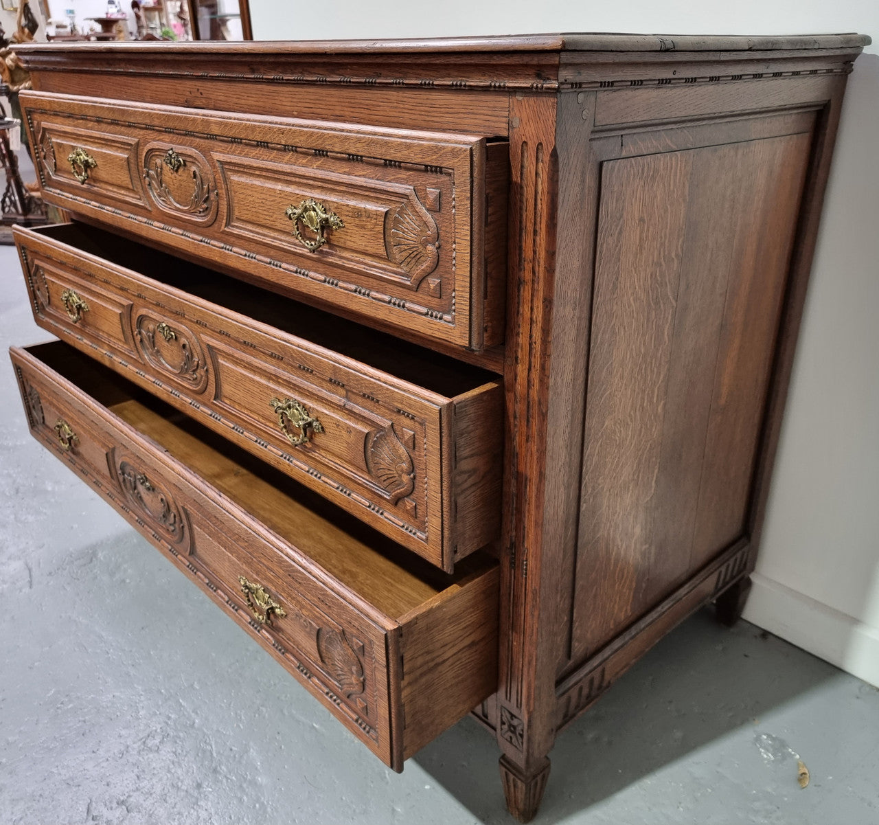 Early 19th Century French Oak chest of three drawers. It has beautiful handles and carvings. It is in good original detailed condition.