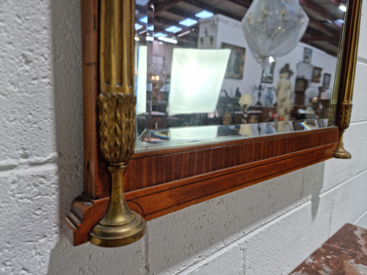 Decorative late 19th Century mahogany French wall mirror with brass swivel candle holders and brass detail. In good original detailed condition.