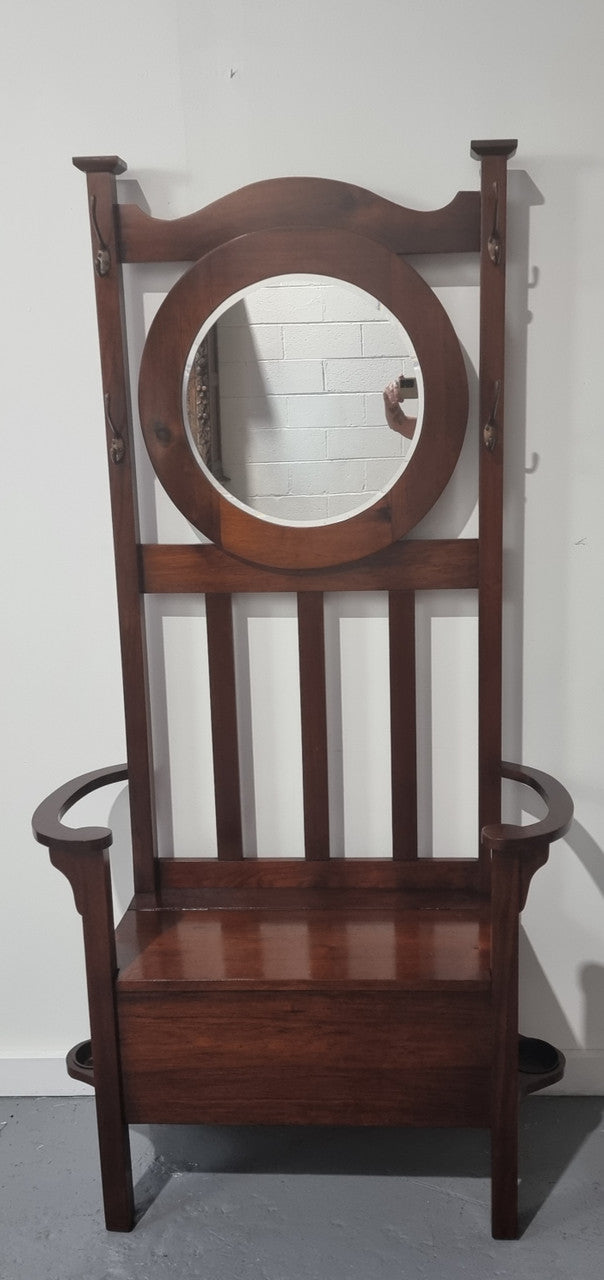 Blackwood Federation hall stand of pleasing narrow proportions. Beautiful round mirror with four lovely hooks and a lift up sit for added storage. In good original condition.