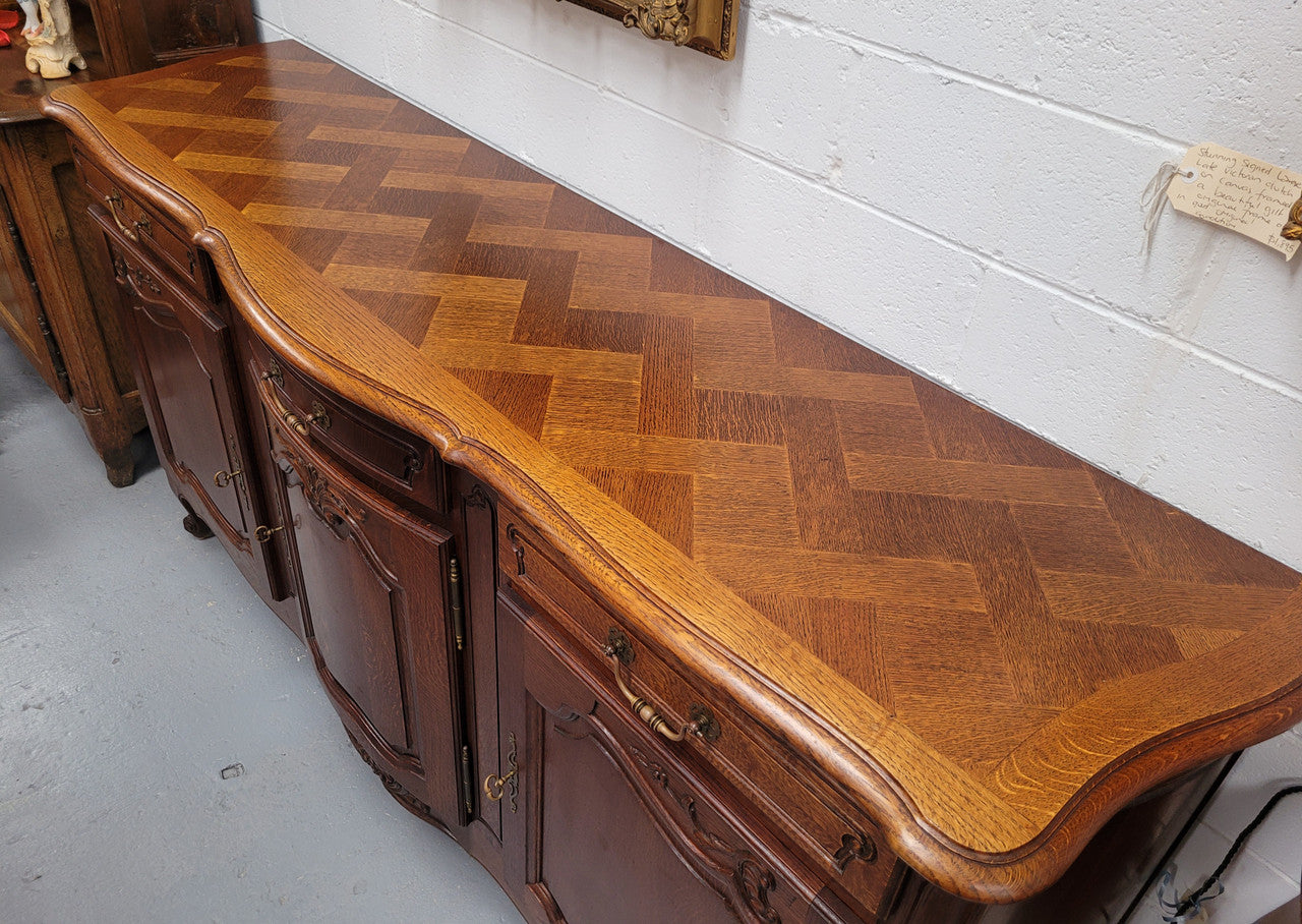 French Oak Louis XV style three drawer three door parquetry top sideboard. It has been sourced from France and is in good original detailed condition.