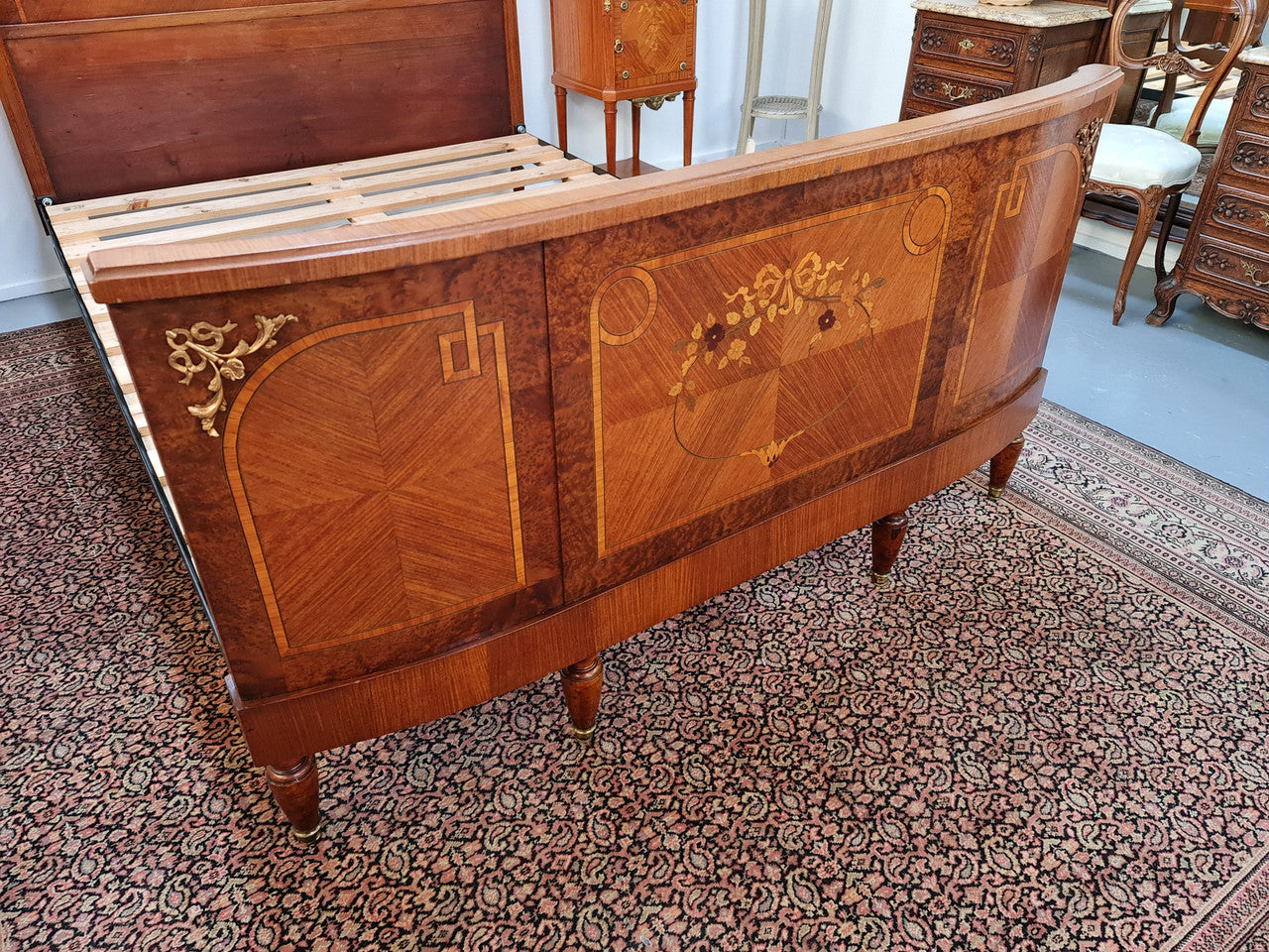 A high quality French Louis XV style bow fronted Queen size bed with marquetry inlay and ormolu mounts. In good original detailed condition. Circa: 1920
