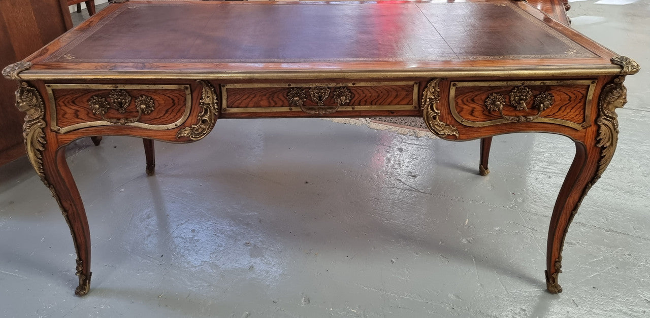 Beautifully fully restored French Antique Rosewood partners desk with beautiful ormolu detail and lovely tooled new leather top. There are three functioning drawers on one side for all your storage needs.