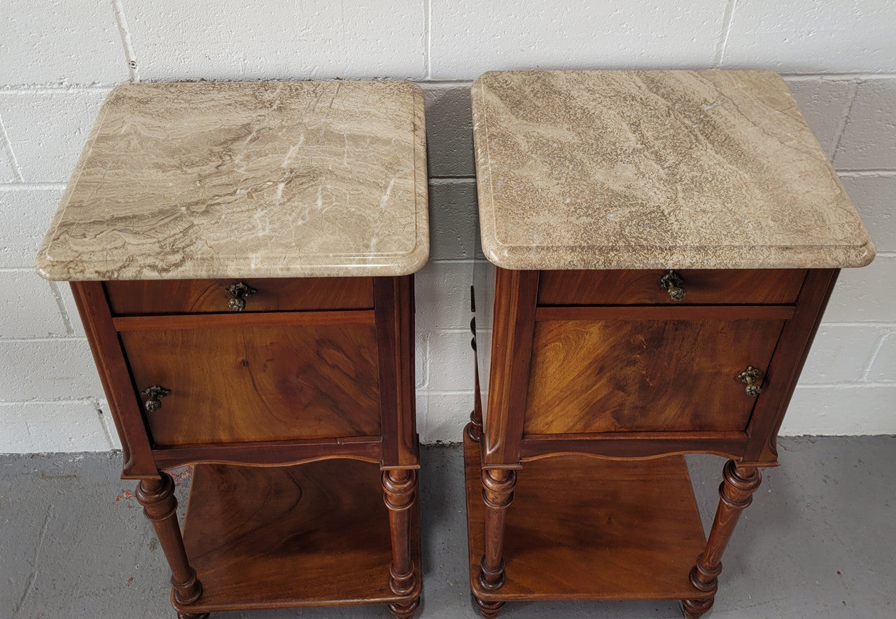 Pair of Louis XVI style walnut bedsides with attractive marble. They have one drawer, one cupboard and are in good original detailed condition.