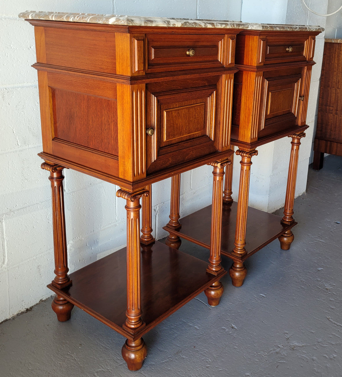 Pair of Henry II style Walnut bedside cabinets with a marble top. Circa 1920s and in good original condition.