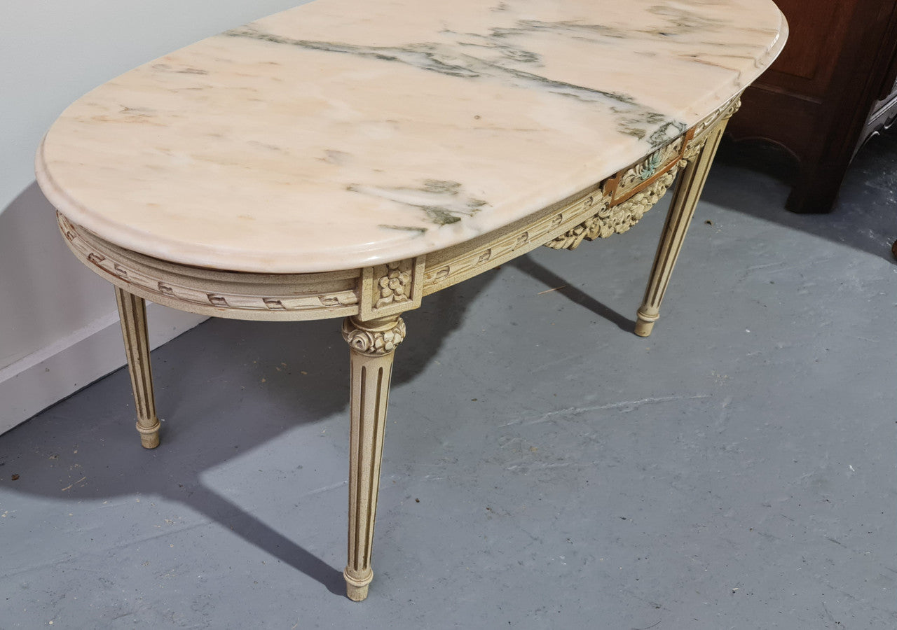 Charming painted Louis XVI style oval marble top coffee table. In good original detailed condition.