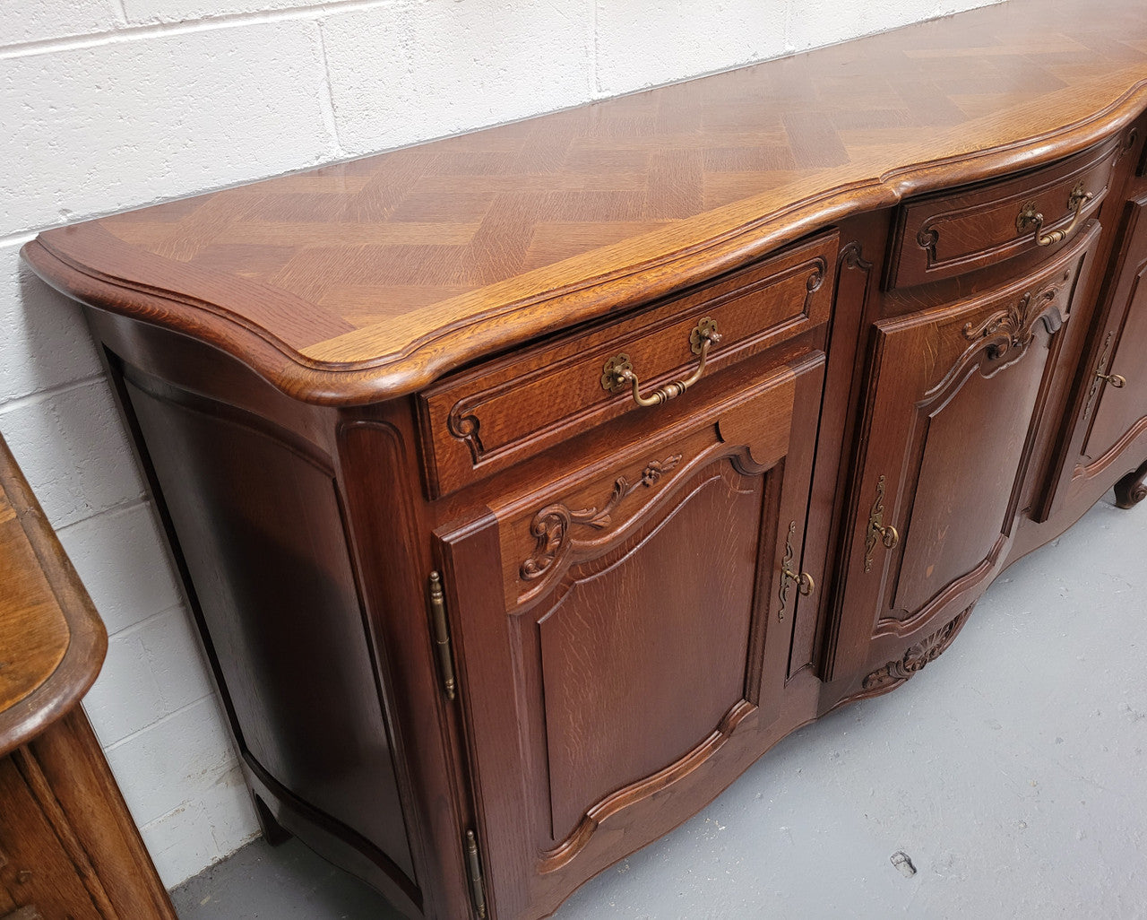 French Oak Louis XV style three drawer three door parquetry top sideboard. It has been sourced from France and is in good original detailed condition.