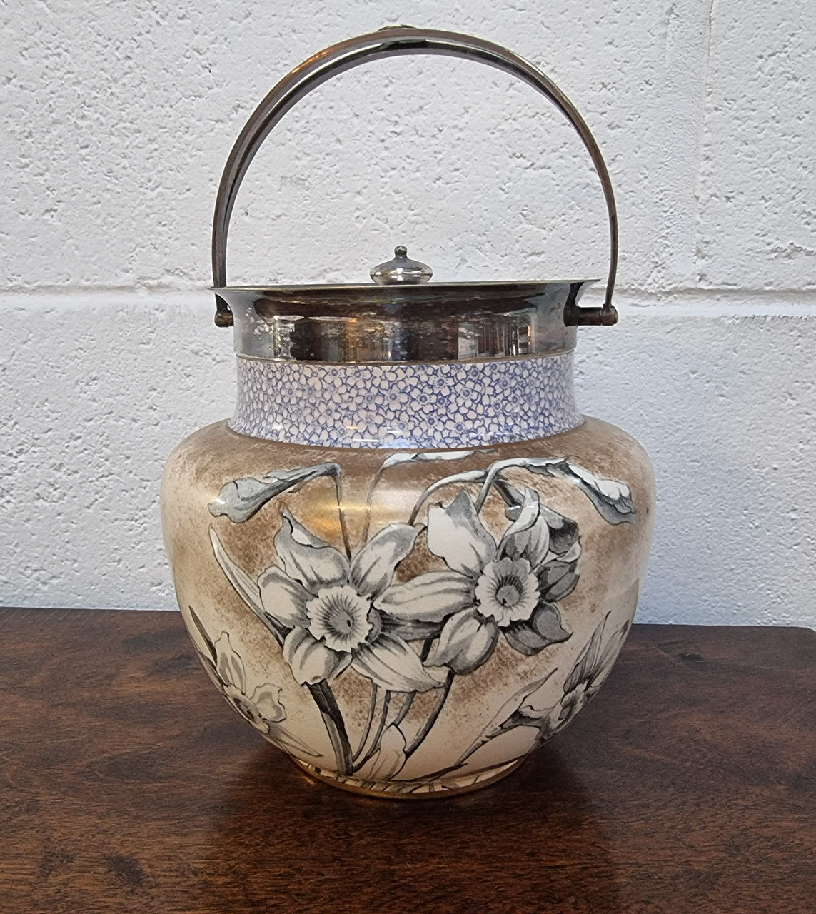 Royal Doulton Biscuit Barrel with silver plated top, handle and lid. Displaying a Daffodil pattern. In original condition please view photo's as they form part of the description.