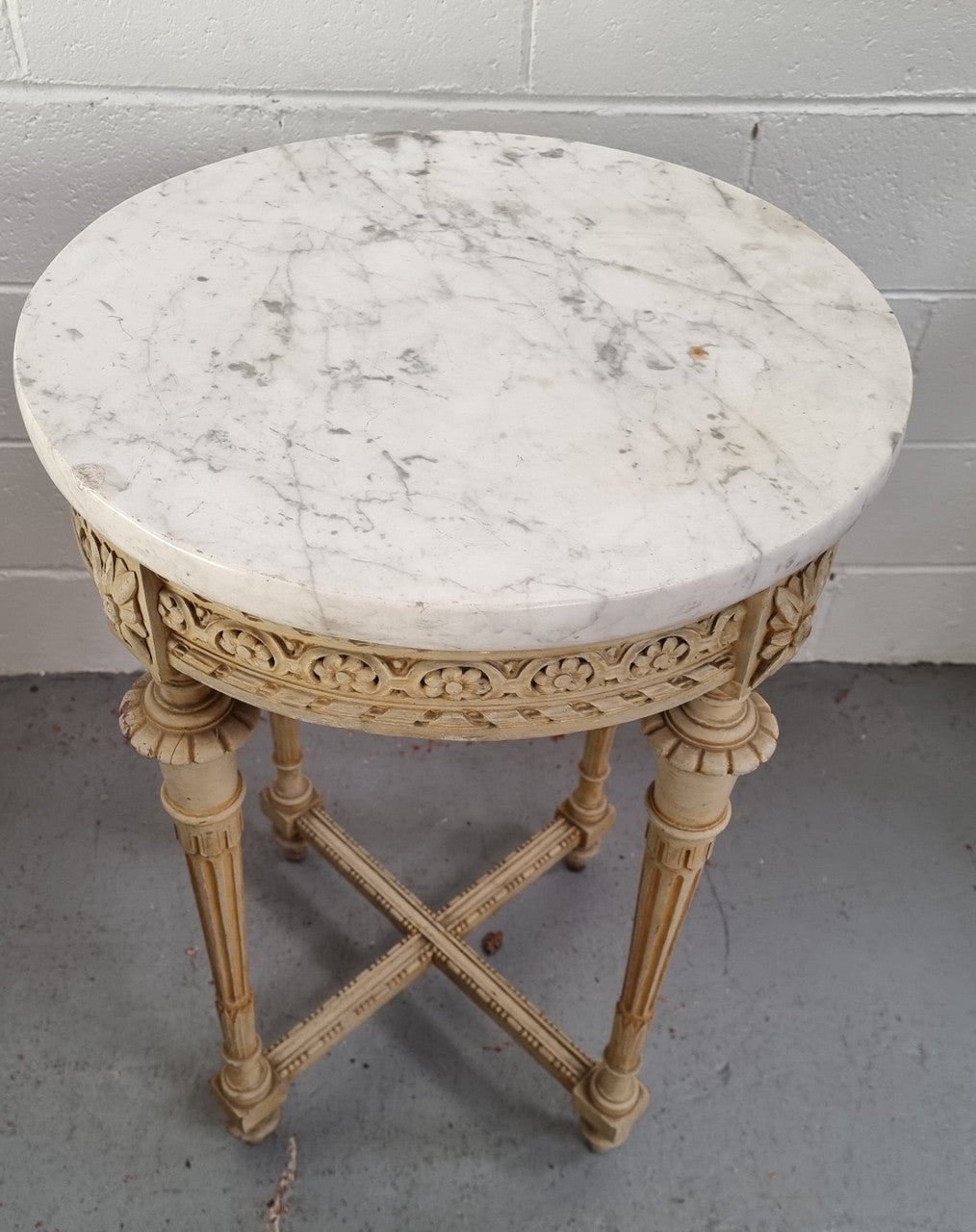 Louis XVI style round side table with original paint and a beautiful thick marble top. It is in good original detailed condition.