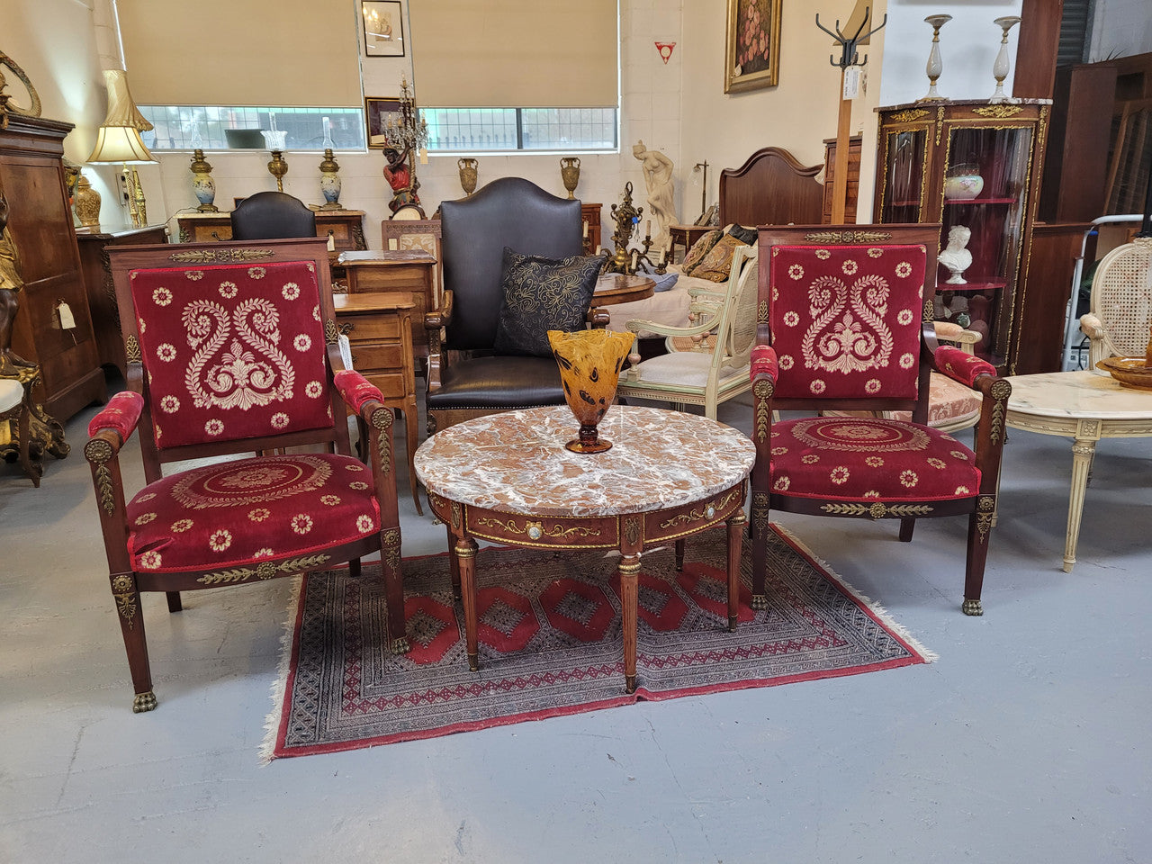 Stunning Antique French style Burr Walnut marble top coffee table. It has gilt metal mounts all around the top edge, with more down the fluted legs & feet. It also has exquisite painted porcelain plaques encased in gilt metal laurel wreaths all around the top edge. It is also stamped underneath "Muarva S.L. Made In Spain". It is in good original detailed condition.