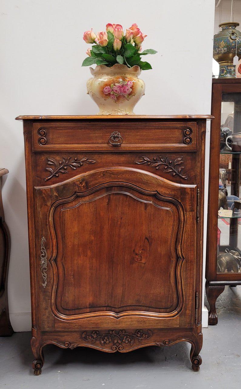 Louis 15th style walnut cupboard consisting of one drawer and two shelves. A pleasing unit with charming carvings. Circa: 1920's. In good original detailed condition.