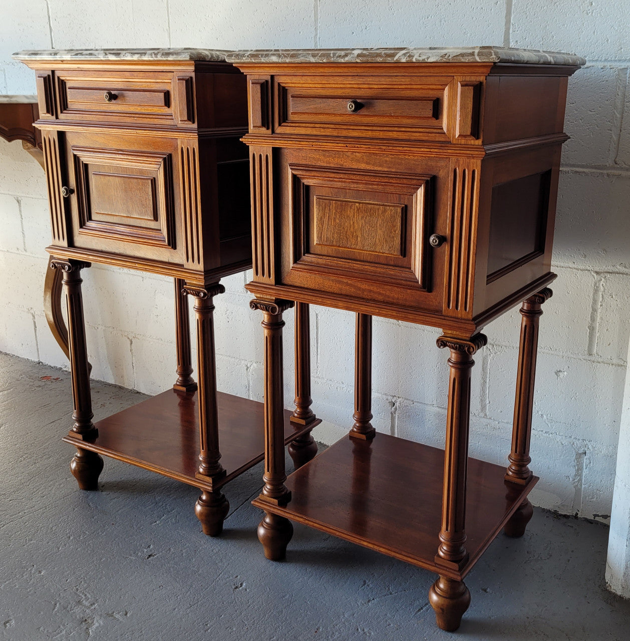 Pair of Henry II style Walnut bedside cabinets with a marble top. Circa 1920s and in good original condition.