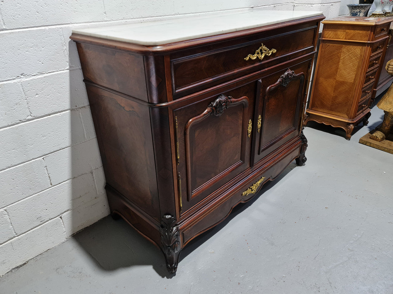 Stunning Rosewood Marble Topped Secretaire with two cupboards. Cupboards open to three fitted drawers and an additional secret drawer beneath the cupboard. All sitting on lovely carved legs and decorated with ormolu mounts. Circa: 1860. In good original detailed condition.