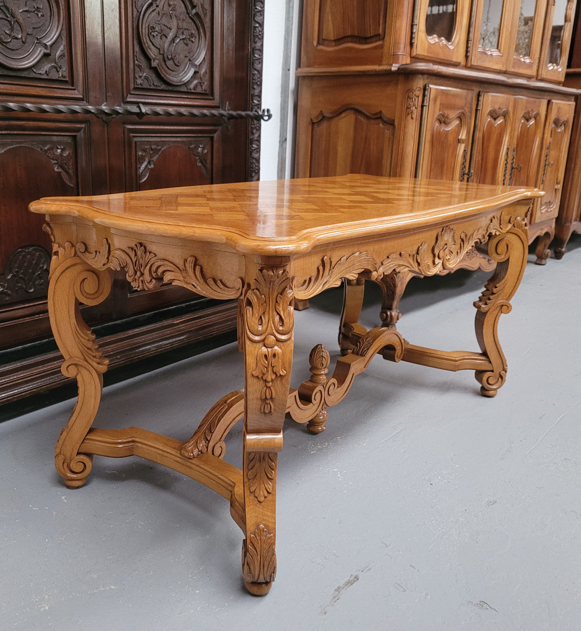French Oak parquetry top coffee table with decorative carved base. It is in good original detailed condition.