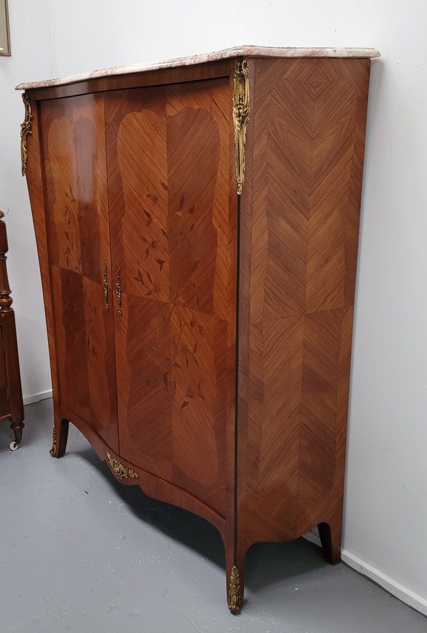 French Louis 15th style Kingwood marquetry inlaid two door cupboard with a beautiful marble top. It has three adjustable shelves and decorative ormolu trim. It has been sourced from France and is in good original detailed condition.