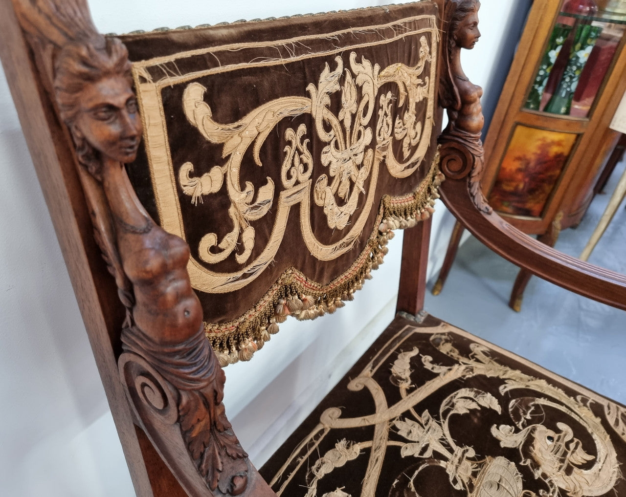 Beautifully carved Walnut Egyptian Revival armchair with amazing hand sewn Stumpwork embroidery coverings. In good original detailed condition.