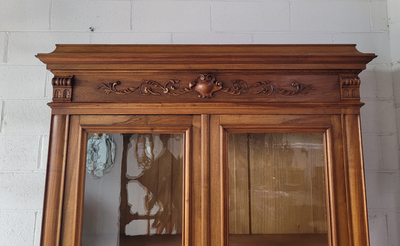 Stunning French Walnut Henry II style two door bookcase with four fully adjustable shelves. The lock on the door is functional and has a key. It is in good original detailed condition.
