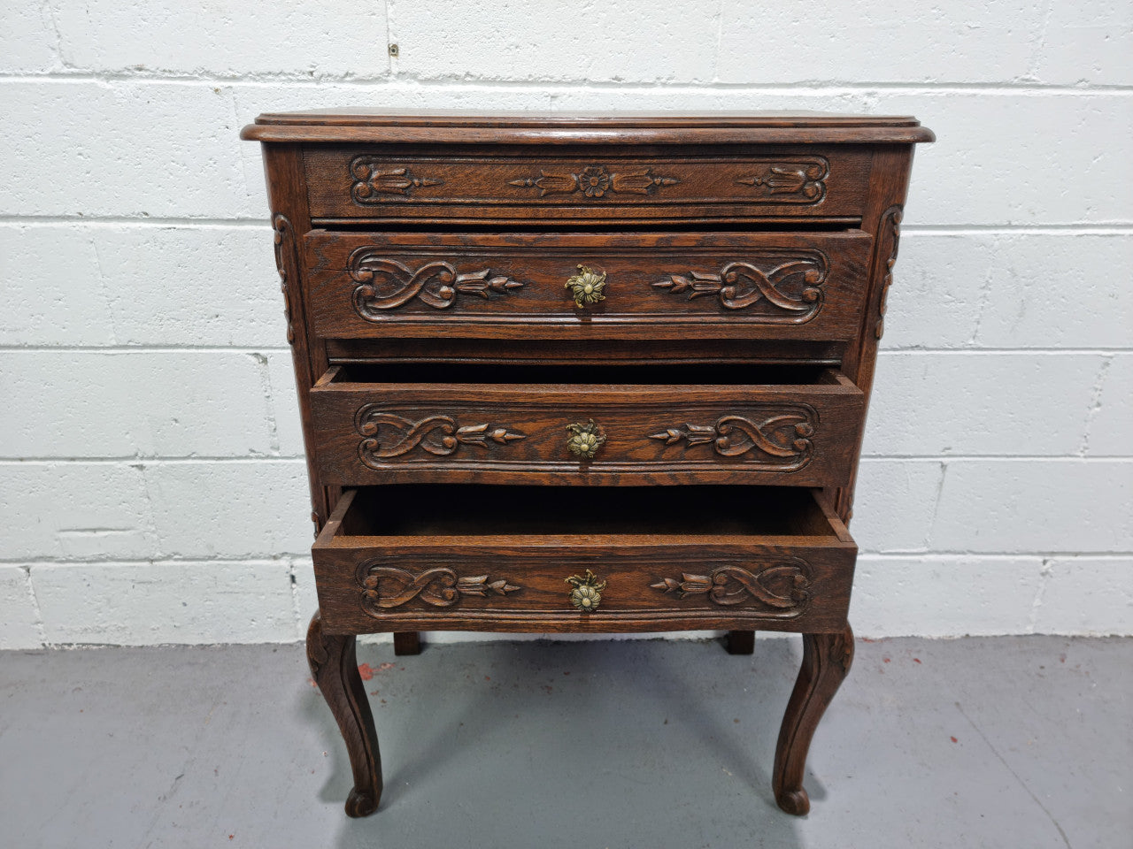 Lovely French dark oak chest of 3 drawers with beautiful carving and details. In good original detailed condition.