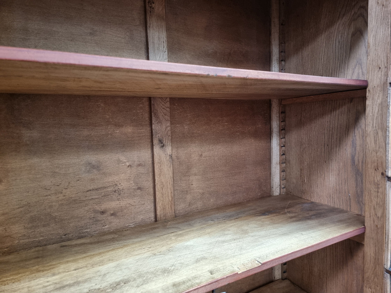 French light Oak two door bookcase with four adjustable shelves. It has beautiful decorative carving and is in good original detailed condition.
