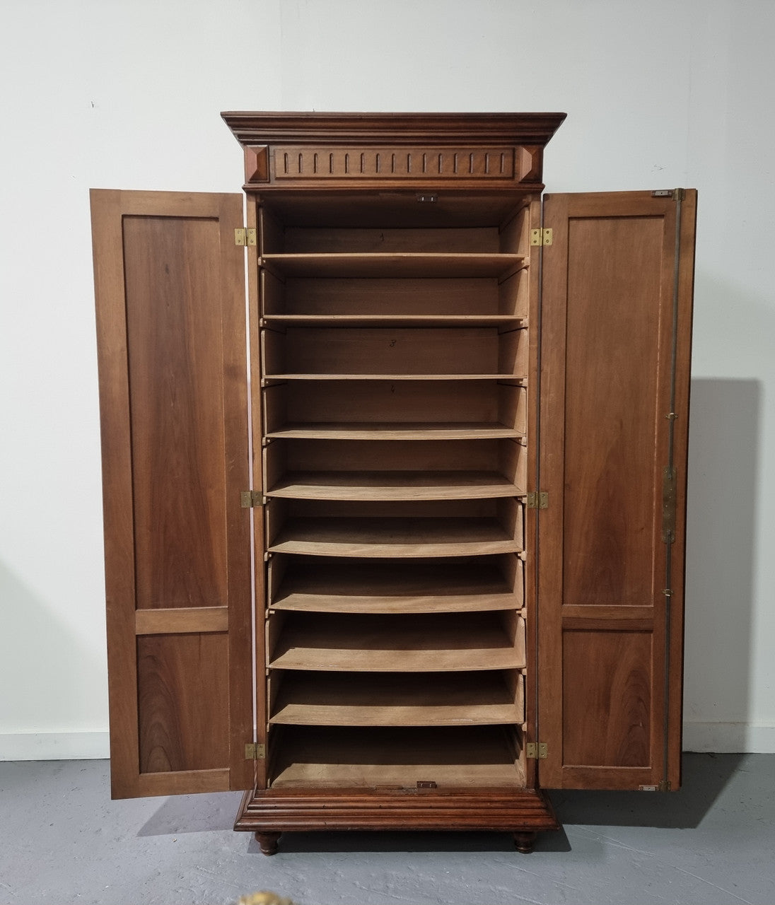 French Henry II style Walnut linen storage cupboard with nine pull out shelves. This piece could be very functional for a range of different purposes including shoe storage. It is in good original detailed condition, please note the door lock no longer functions and opens by pulling the door.