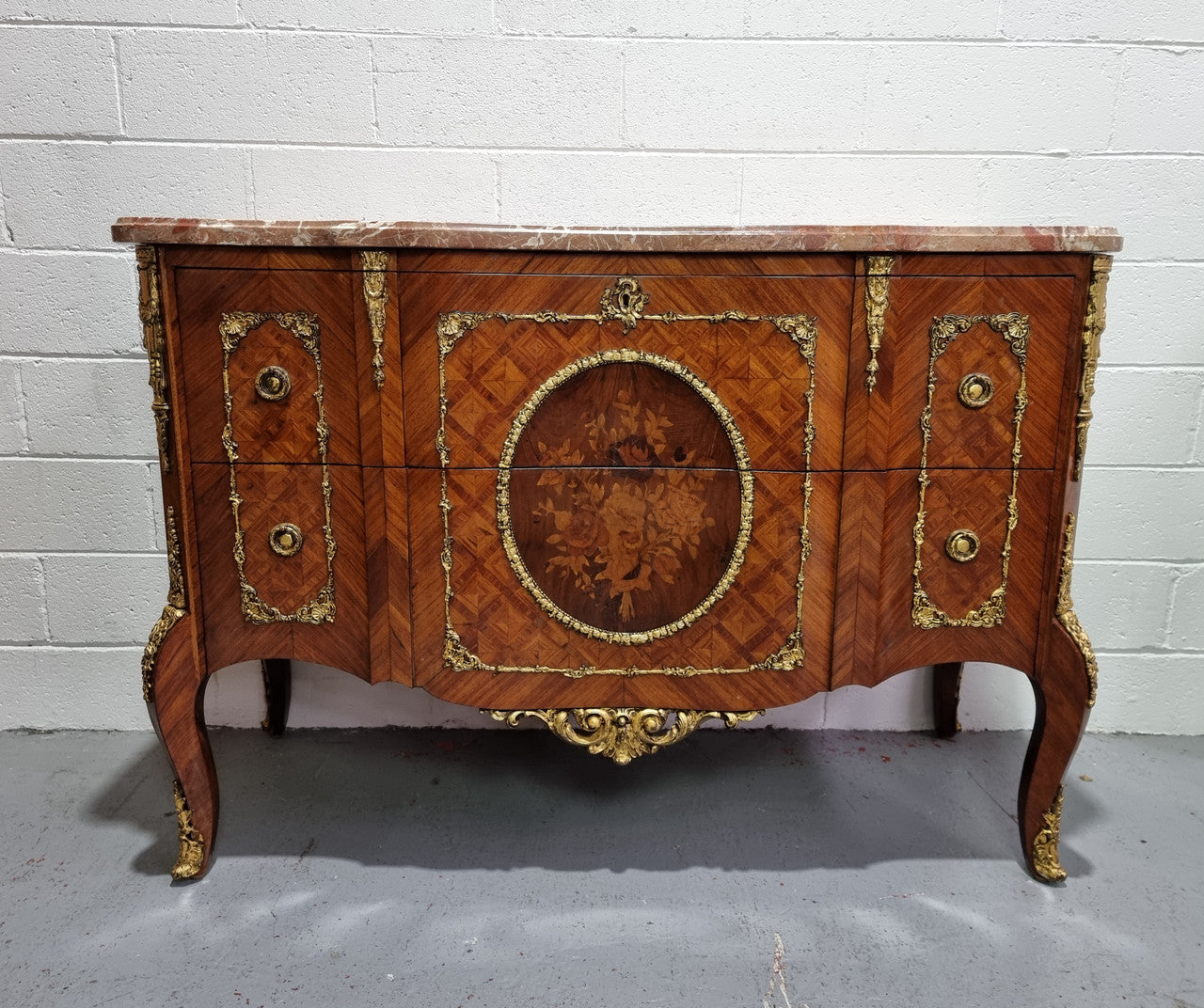Stunning Louis XV style ormolu and marquetry marble top commode with two drawers. It has an amazing thick marble top and it is in good original detailed condition.