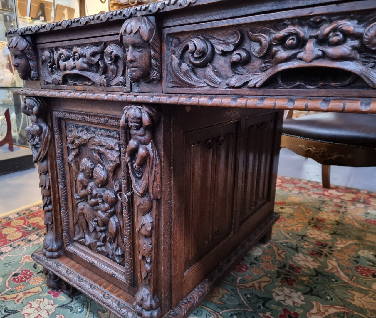Beautifully carved French Oak early 19th century pedestal desk with 3 drawers, two cupboards and a secret cupboard on the side. There is also a lovely burgundy tooled leather top. In good original detailed condition.