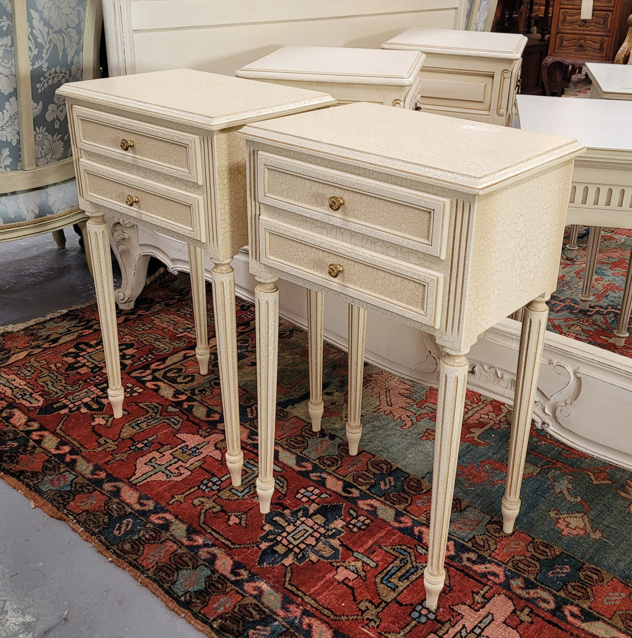Pair of Vintage Louis 16th style painted crackle finish two drawer French style bedsides. They have elegant reeded legs and have been sourced from France. They are in good original condition.