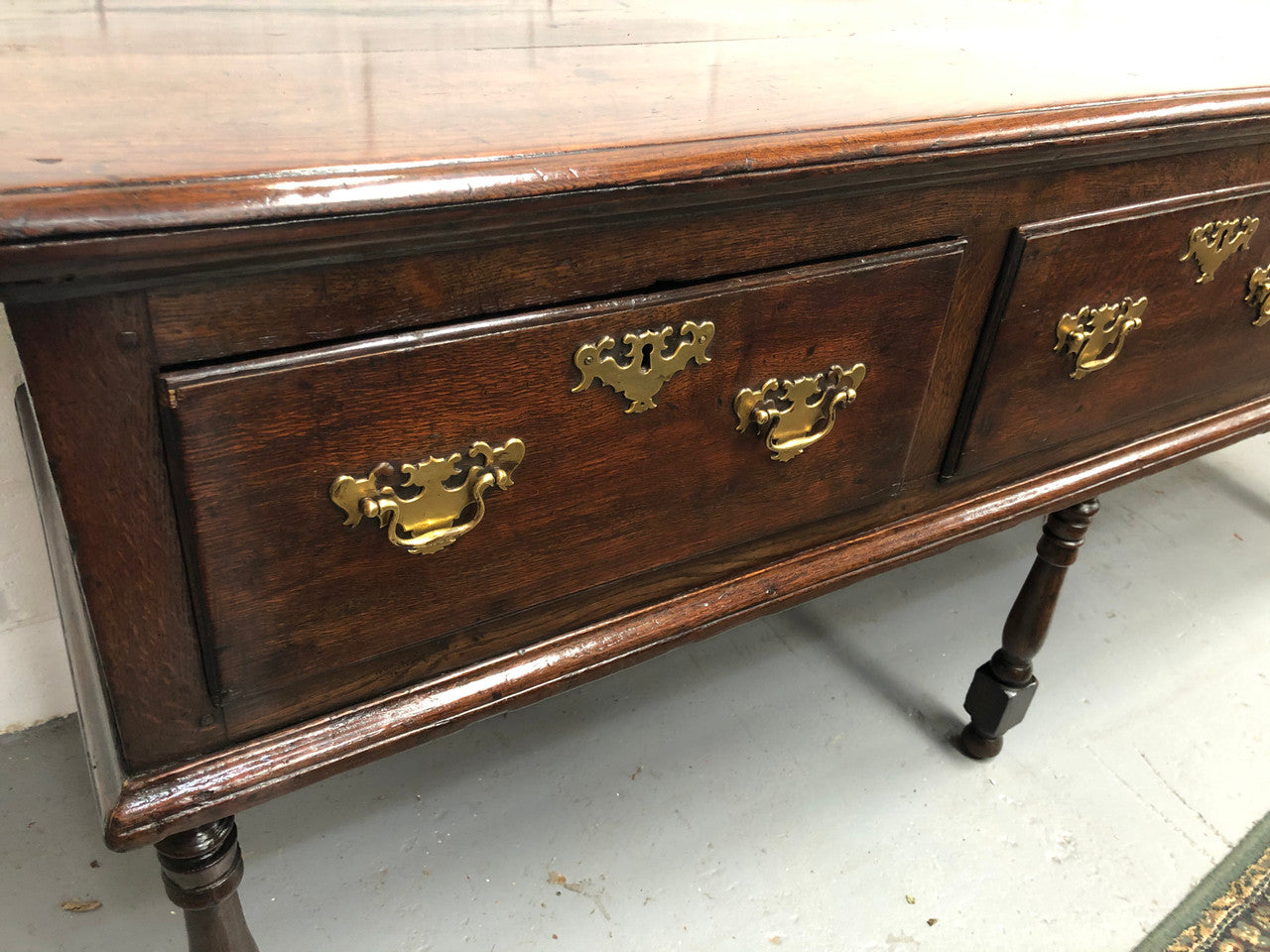 Early 19th Century English Oak dresser base with three large drawers. In very good original detailed condition.