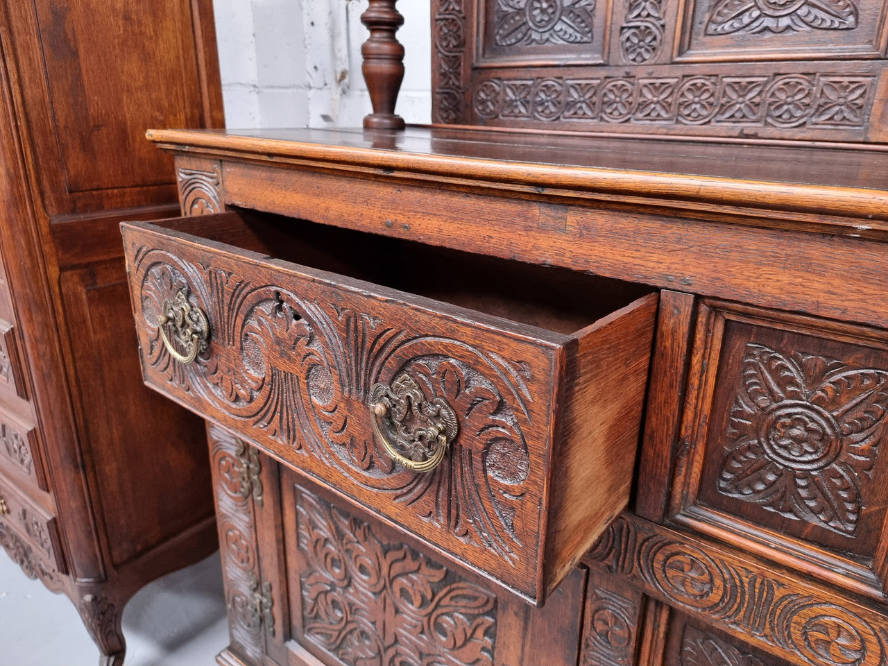 Impressively carved 18th Century English Oak kitchen dresser in 17th Century Jacobean style. It is in good original detailed condition and has been sourced from France.