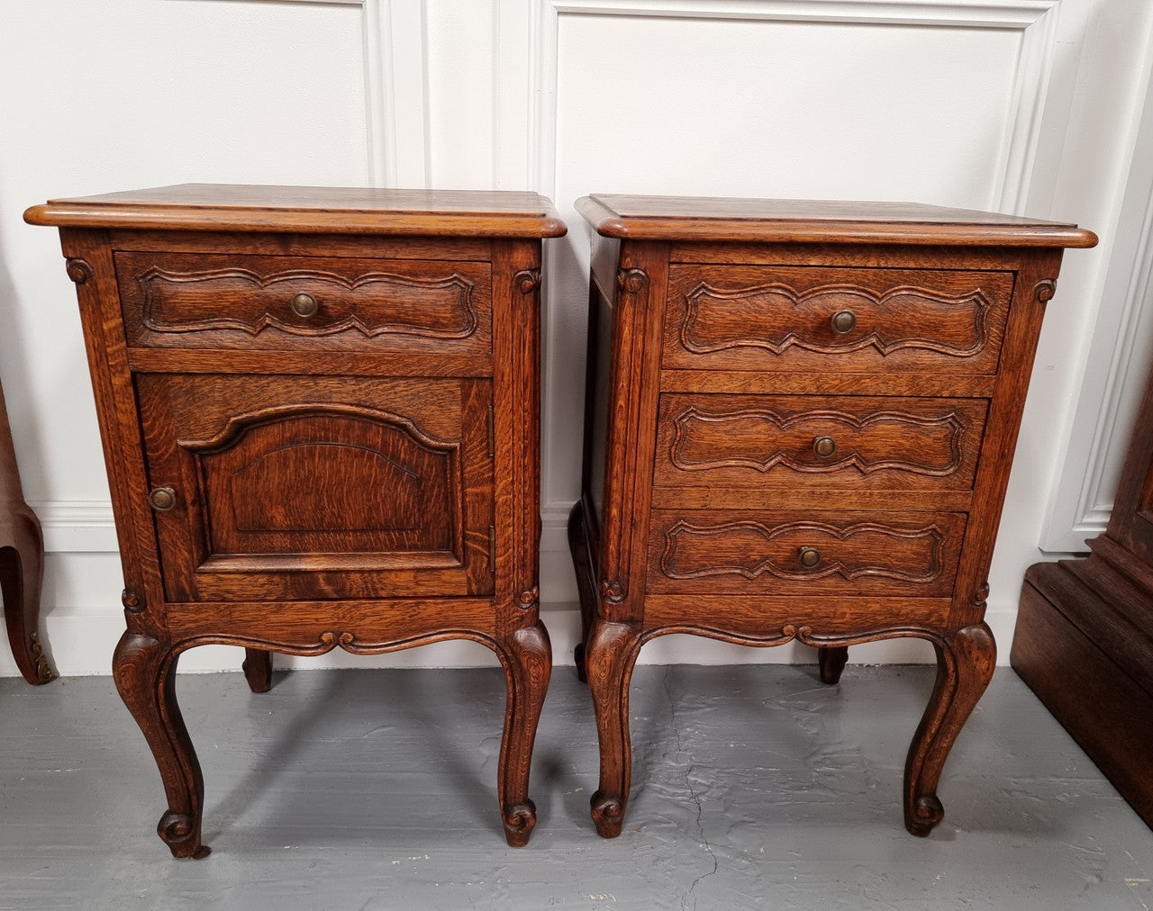 Pair of French provincial Oak bedsides. They have attractive cravings and there is one with three drawers and other one has a cupboard and a drawer. They have been sourced from France and are in good original detailed condition.