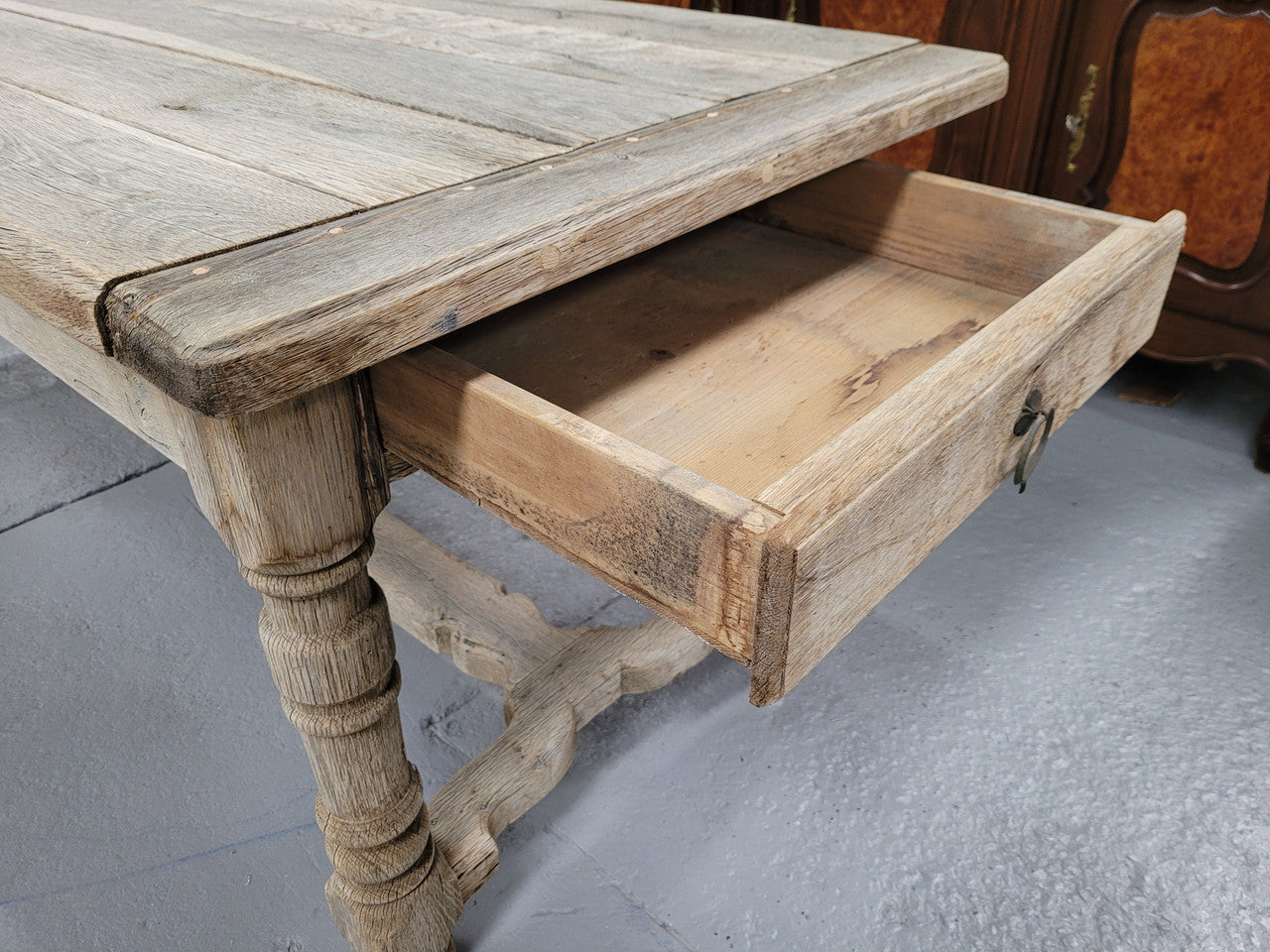 French stripped Oak pedestal stretcher base Farmhouse table with two drawers on either side of table. Features raw wood that could be used as is for a distressed look, or finished and waxed for a more refined look.