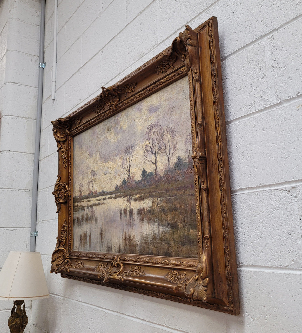 Sourced from France an impressionist oil painting of a beautiful lake scene. It is nicely framed in an Antique frame and in good original detailed condition.