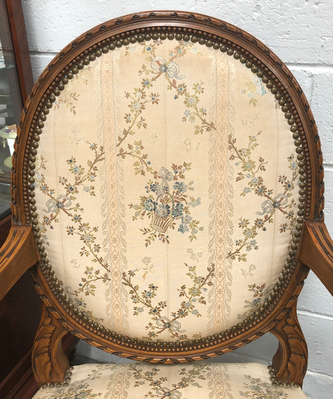 Pair of Antique French Louis XVI style carved Walnut fauteuils in restored condition. The Tapestry upholstery is in good condition some marks and wear but usable.