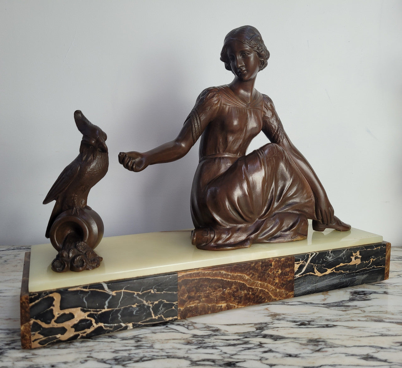Art Deco bronze statue with brown patina of a lady and parrot on marble base. Signed by Italian Sculptor A Trefolini, an highly regarded sculptor, in very good condition.