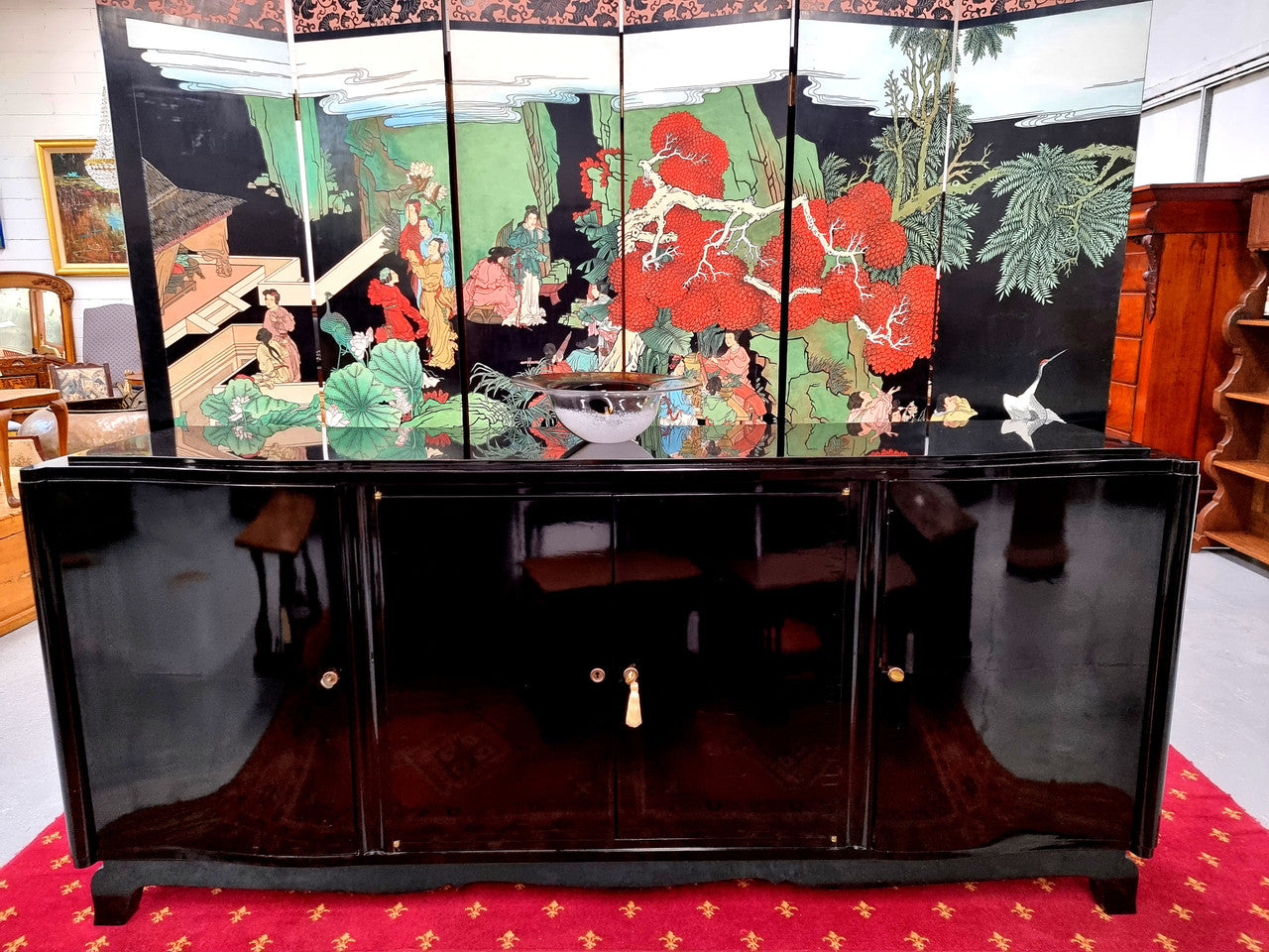 French Art Deco sideboard with a custom black lacquer finish. Beautiful serpent shaped front with four cupboards with working locks and includes to working keys. It is in original condition.