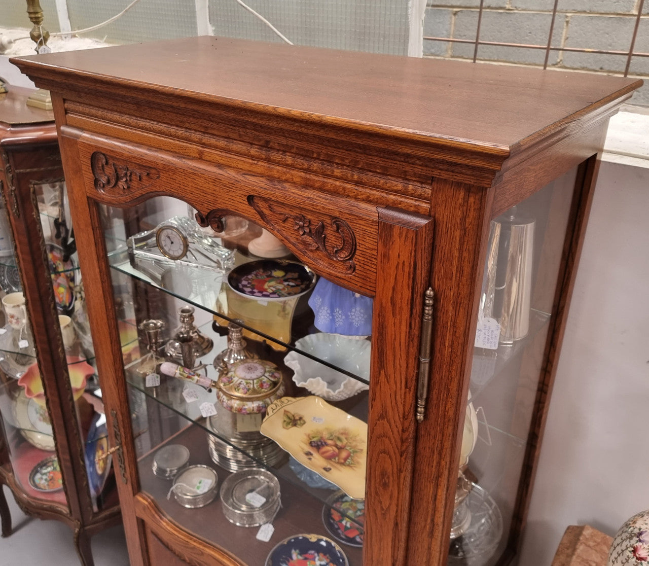 French Oak Louis XV Style Vitrine with two fixed glass shelves at the top and two fixed wooden shelves at the base for added storage. It has been sourced from France and in good original detailed condition.