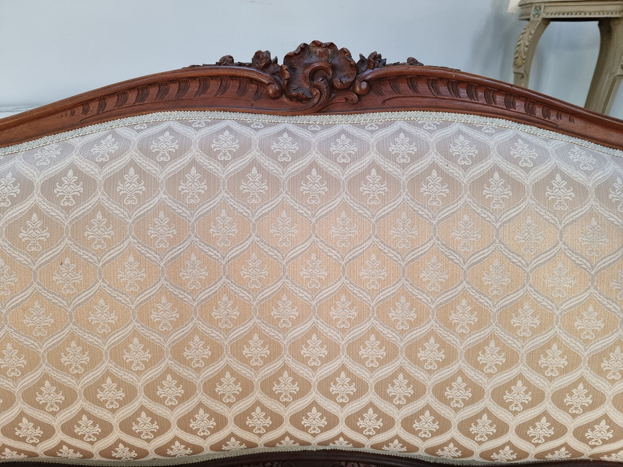 A late 19th Century French Walnut Louis XV style settee with a serpentine front. This settee upholstery is like new and is in very good condition.