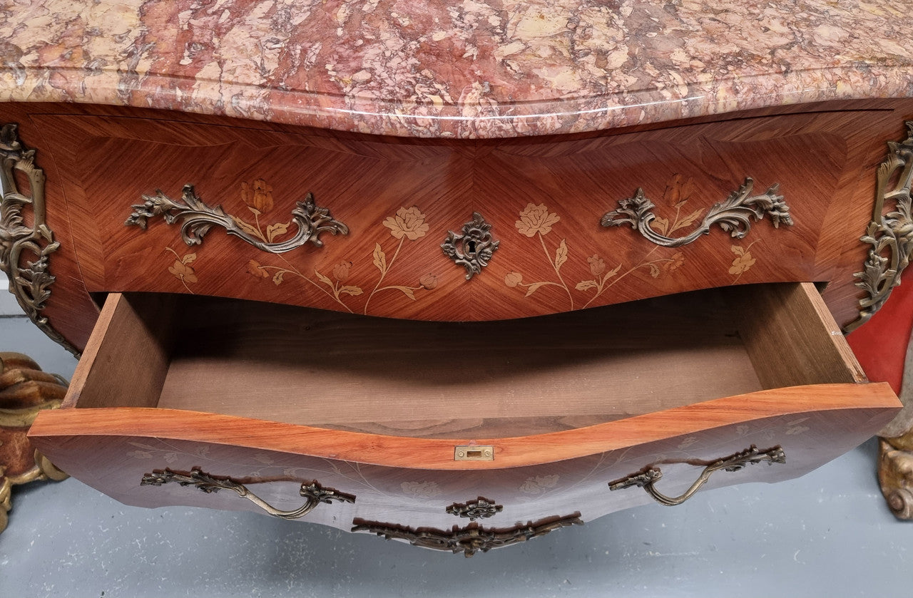 Stunning Louis XV style marquetry inlay marble top two drawer commode. It has decorative ormolu mounts and beautiful marble top. In good original detailed condition.