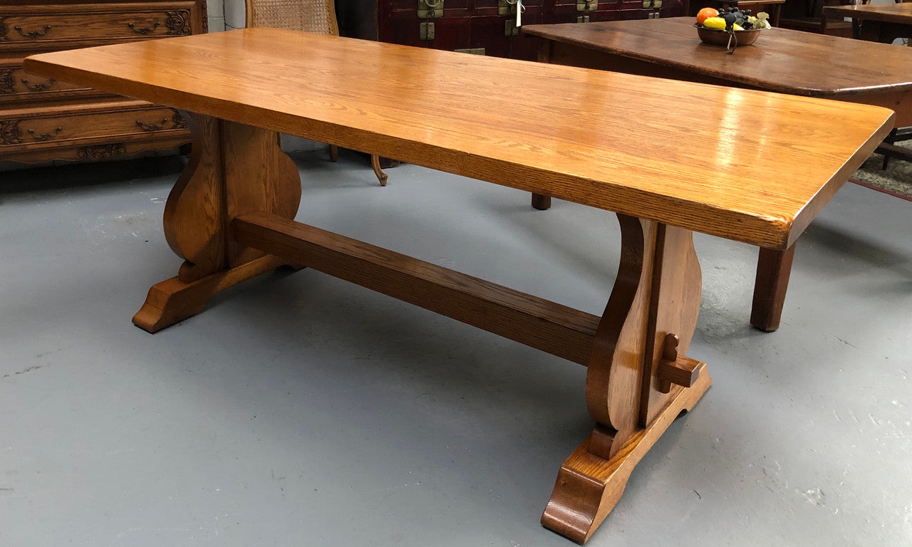 A French Style Oak stretcher base table with amazing wood grain. Can comfortable sit 6-8 people and is in original detailed condition.