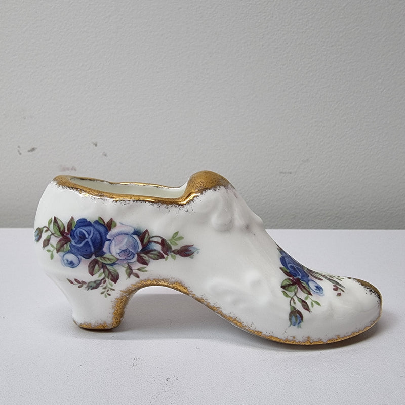 A lovely pair of Royal Albert China shoes in good original condition. Stamped on the sole 'Moonlight Rose: Royal Albert Bone China, England ©1987.