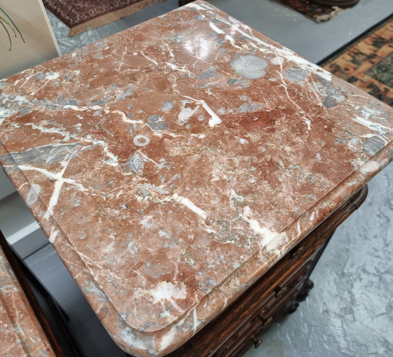 A pair of hard to find French Oak Louis XV style four drawer marble topped bedsides with attractive carvings. They are in good original detailed condition and have been sourced from France.
