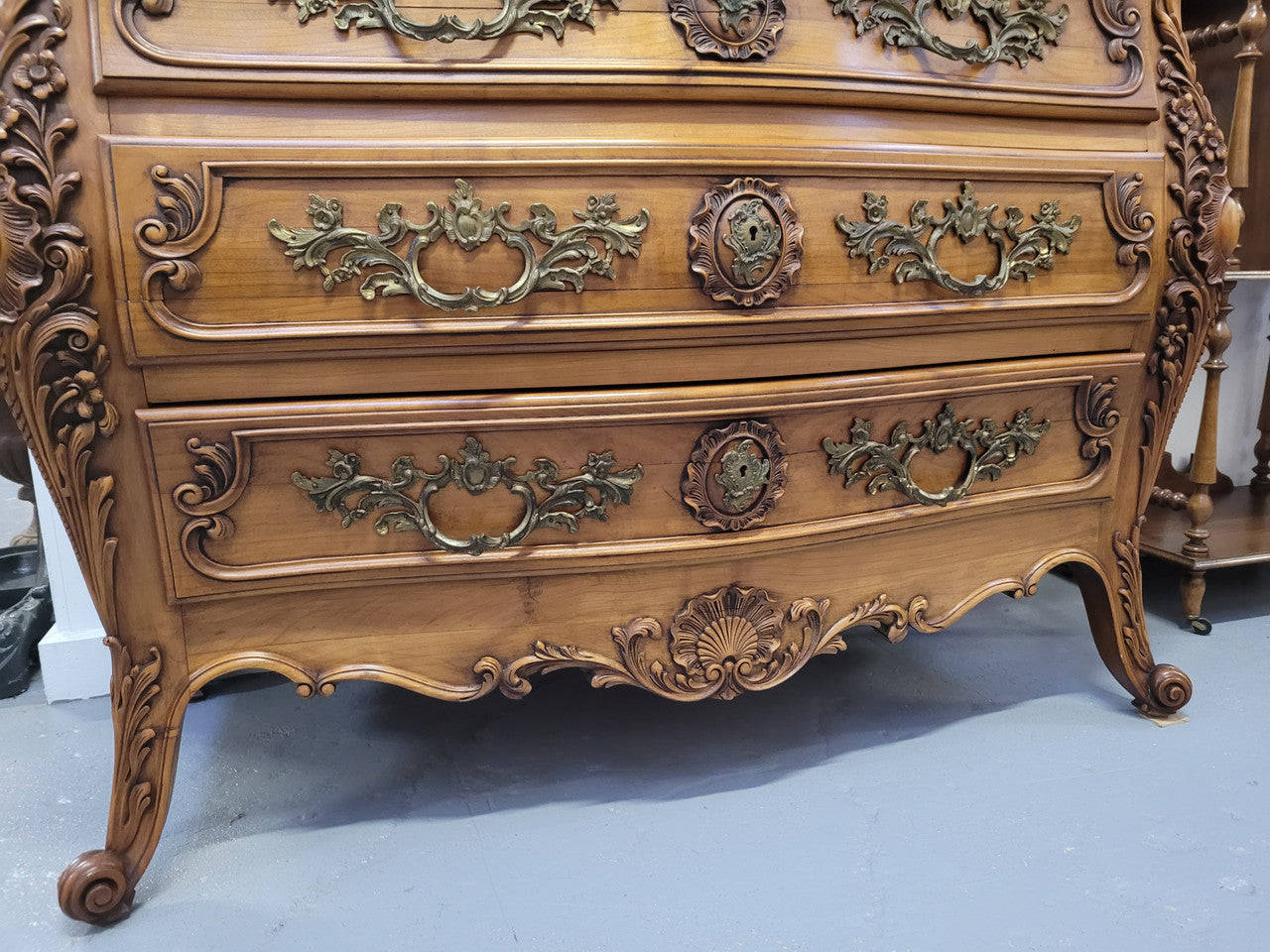 Impressive Louis XV style three drawer walnut commode. Ormolu handles and bevelled marble top complimenting detailed carving. In very good original detailed condition.