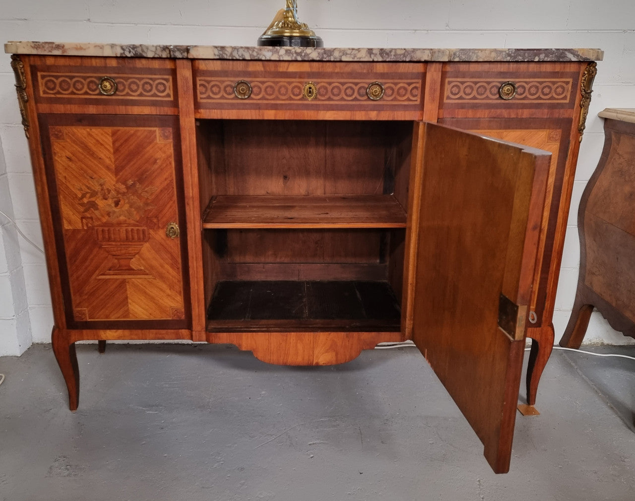 A high quality 19th Century French marquetry inlaid Kingwood marble top credenza. It has an attractive solid marble top and decorative marquetry inlay throughout. It has plenty of storage space with three drawers and three doors. It has been sourced from France and is in good original detailed condition.