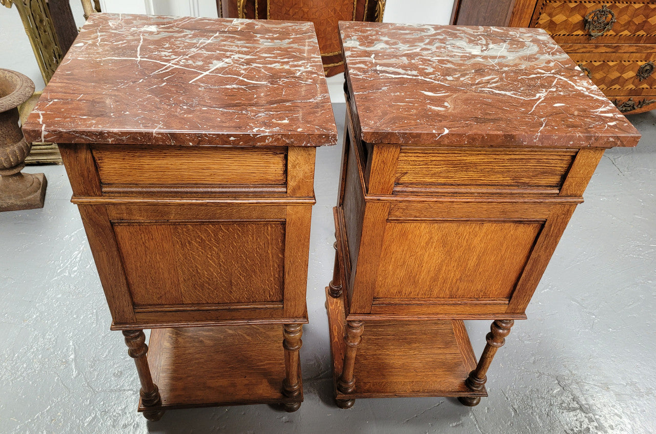 Pair French Oak Henry II style rouge marble topped bedside cabinets. Consisting of one drawer, one cupboard and a bottom shelf. Carved decoration and turned legs. Circa: 1900's.