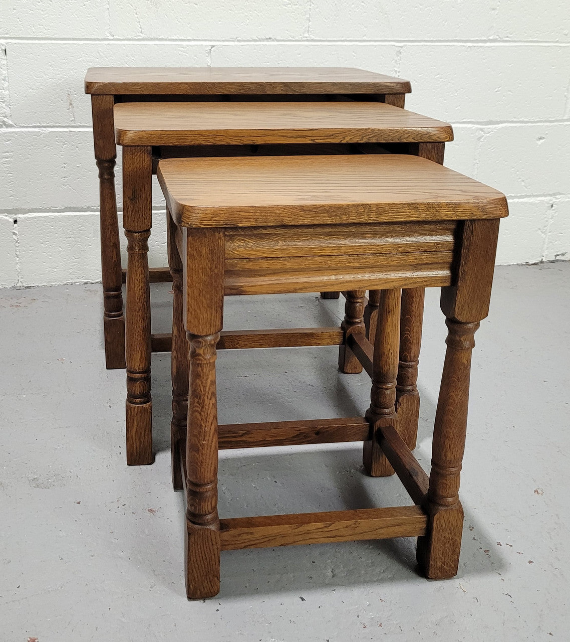 Lovely tudor oak style three nest tables. Circa 1950, In good original detailed condition.