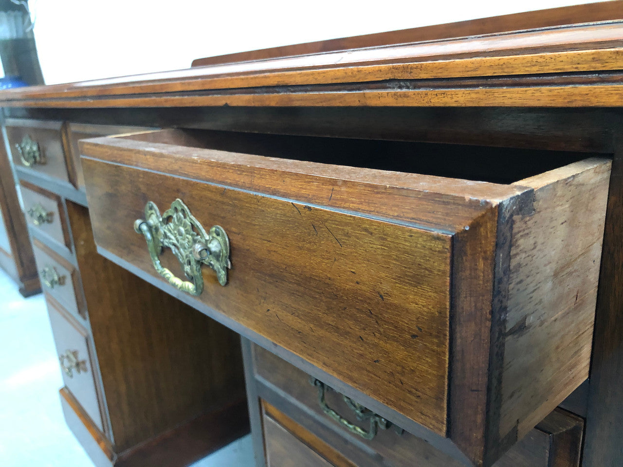 Fabulous small size walnut desk, with nine drawers and decorative brass handles and in good original condition.